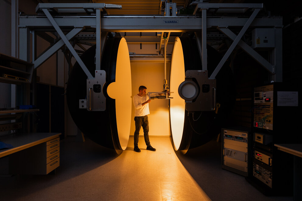 Person who measures the luminous flux of a street light using an integrating sphere.