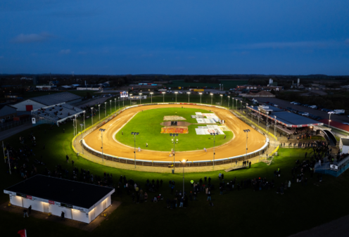 The illuminated Vojens Speedway Center photographed at night.